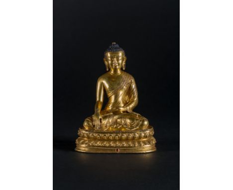  A gilt copper figure of Buddha SakyamuniTibet, 15th - 16th century Noticeable sculpture depicting the Gautama Buddha, in his