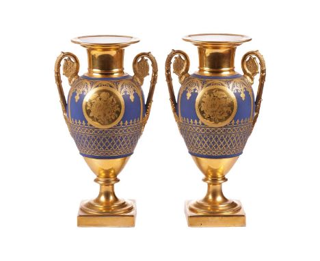 A pair of late 19th-century French pedestal vases, (possibly Paris Porcelain), gilt decorated on a dark blue ground, with scr