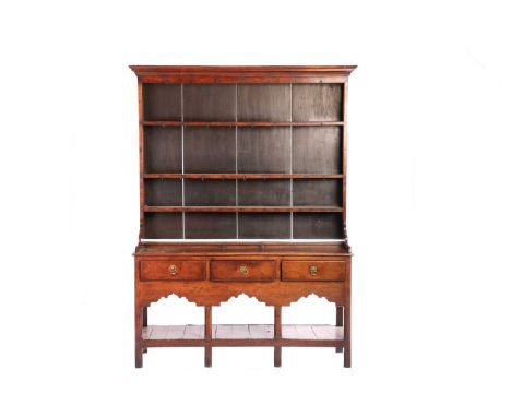 A George III oak pot board dresser and Delft rack, the moulded cornice over three shelves with hooks, the dresser with three 
