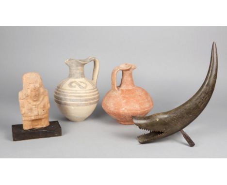 A Cypriot pottery jug with a trefoil spout and with black linear and S decoration, 22cm high, a terracotta jug, a Mayan style