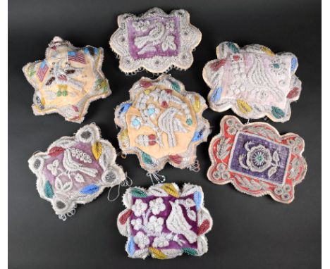 Seven Iroquois beaded pin cushion whimsies cotton with clear and coloured glass beads, four rectangular with scalloped edges 