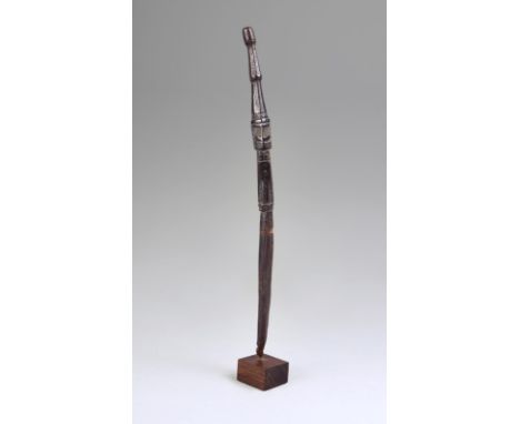 A Korvar charm Geelvink Bay, Irian Jaya with a central ancestor figure and a tapering faceted finial, the lower section inscr