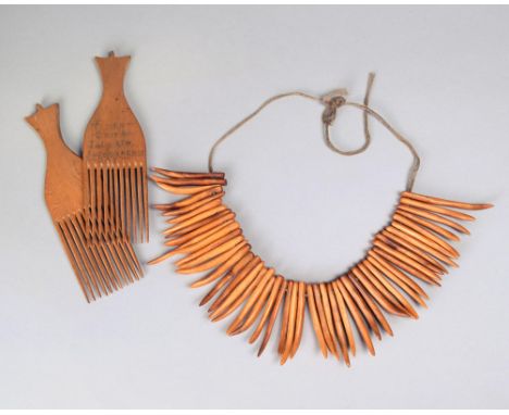 An Oceanic necklace with fifty carved bone points with curved tips, the longest 9.2cm long, and two Fiji wood combs, inscribe
