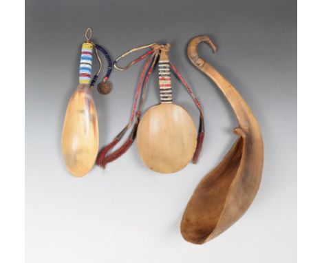 A Sioux horn and quill spoon with an oval bowl and quilled handle with a pointed terminal and hung with buckskin, quill, tin 