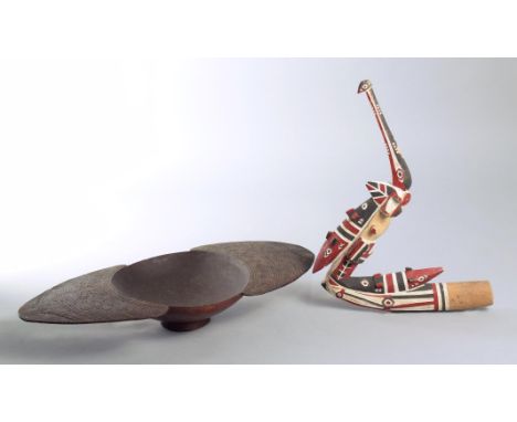 A Massim bowl Trobriand Islands, Papua New Guinea circular with large fin lifts with carved decoration, 51.5cm across lifts, 