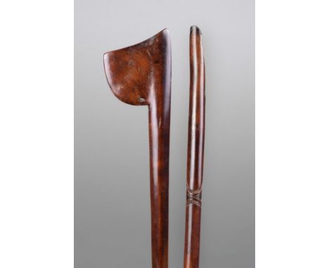 A Maori tewhatewha club New Zealand with an axe shape blade, pierced at the base, with an elliptical tapering shaft having a 