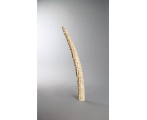 λ A Loango tusk Angola ivory, relief carved a spiral procession of figures and animals, including two figures paddling a cano