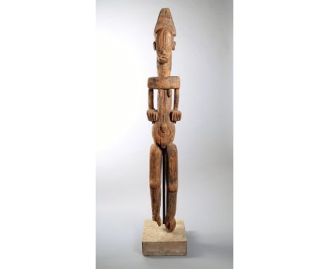 An Igbo Alusi figure Nigeria the standing female with a pyramidal coiffure and with forehead scarification, elliptical ringed