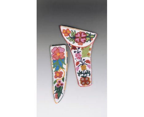 A Chippewa beaded pistol holster buckskin, cloth and coloured glass beads, with a white ground and floral decoration, the fla