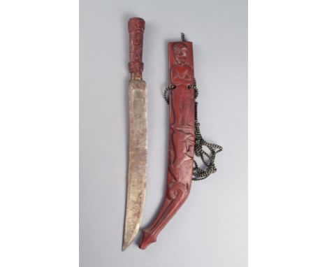 A Paiwan sword Taiwan with a steel blade with a wood handle carved masks and with an open scabbard carved a figure, a deer an