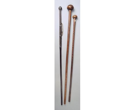 Three Zulu staffs South Africa one of knobkerrie form, 100cm long, the others with spiral stem, the lighter with a metal tip,