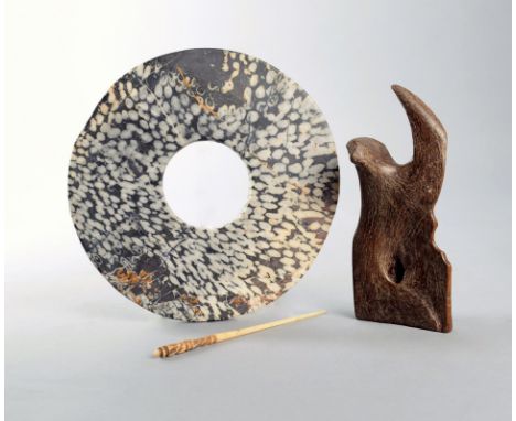 A Siberian ox bone tool 18.5cm long, a Chinese stone bi disc, 21.5cm diameter, and a Congo carved bone hair pin, with a mask 