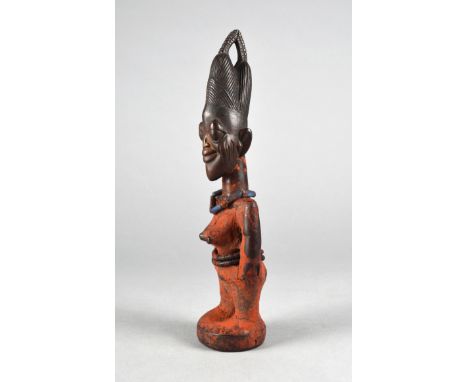 A Yoruba Ibeji female figure Igbomina, Nigeria with a twin domed coiffure with a top open link and front crescent, with an an