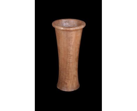 An Egyptian alabaster vessel Early Dynastic Period, 1st Dynasty, 2972 - 2793 BC of waisted cylindrical form with a rim, 21cm 