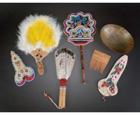 An Iroquois fan with Niagara floral beadwork front and a layered silk back and a wood handle, 35.5cm long, a Maliseet feather