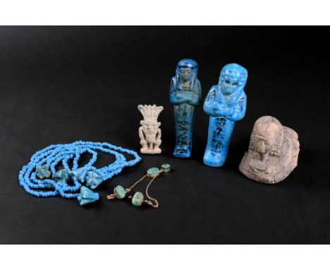 Three Egyptian faience scarab beads with hieroglyphs to the bases, and a smaller beads, later mounted in gilt metal as a broo
