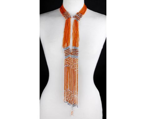 Four South African beaded neck pieces with long fringes, the longest 108cm, and a body ornament with two geometric panels and