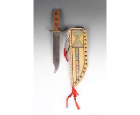 A Blackfoot scabbard and knife with brass tacks, tin cones and cloth, with geometric pigment decoration, 36cm long, with a Bo