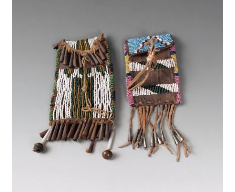 A Southern Plains ration ticket pouch leather, buckskin, coloured glass beads and tin cones, with linear decoration to the fr