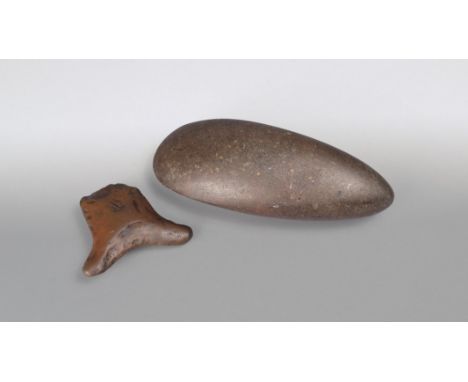 A Taino axe head Caribbean stone, one slide slight more curved than the other, 22.5cm long, and an Inca stone tool, with a bi