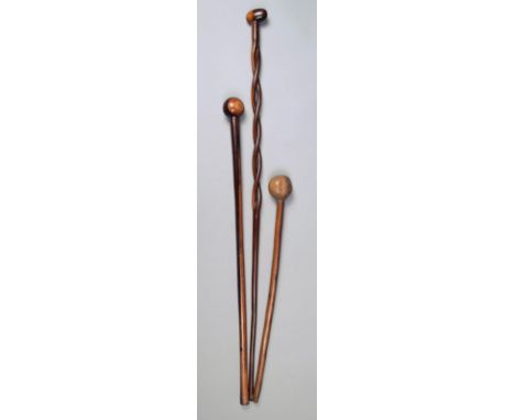 Three Zulu staffs South Africa one with a open double twist shaft and an oblong finial, 94.5cm long, the others with spherica