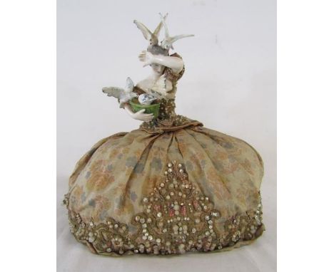 Lady wearing a crinoline dress tea cosy - ceramic figure of lady feeding birds - approx. 15cm