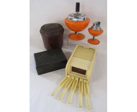 Cigarette dispensers, Bakelite tobacco pot, Souvenir cigarette box and orange ashtray and lighter on stands
