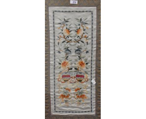 An early 20th century Chinese silk embroidered panel, depicting repeating foliate designs within borders, framed and glazed 7