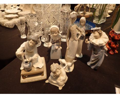 Three Lladro figurines and one Nao with a slight chip