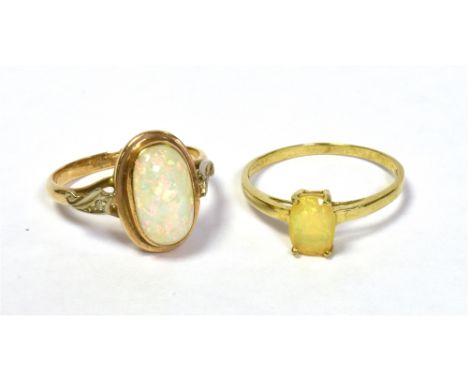 TWO 9CT GOLD &amp; OPAL RINGS one set with an oval fire opal and one set with a solid white opal cabochon, approx 11.5 x 6.8m