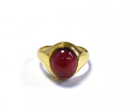 9CT GOLD SYNTHETIC RUBY RING a bezel set oval cabochon cut synthetic ruby, within integral shank, hallmarked 9.375 London 197