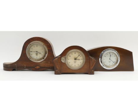 Three early 20th century Smiths car dashboard clocks, having chrome plated bezel, silvered dials with Arabic numerals, mounte