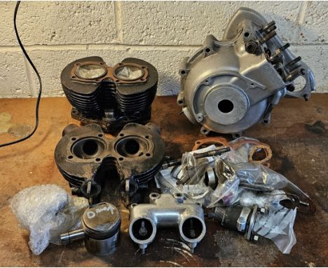 A Triumph 5T pair of alternator crankcases, number 02897, a 5T cast iron head and barrel with piston, and assorted carb manif