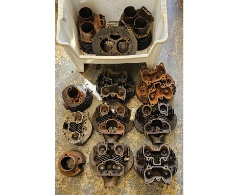 A collection of motorcycle engine parts to include six cylinder heads 