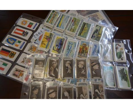 A collection of cigarette and tea cards including a set of Players sepia racing caricatures, Brooke Bond Flags & Emblems, Bro