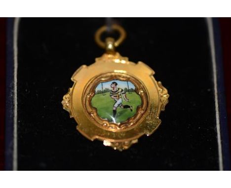 A 9ct gold and enamel Rugby Union medal, decorated with a running figure in coloured enamels, the reverse unengraved, hallmar