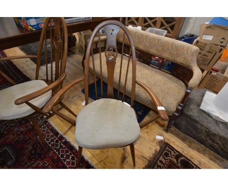 A pair of vintage Ercol swan-back carver chairs