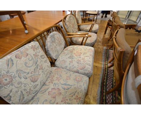 An Ercol beech sitting room suite of two seater sofa and a pair of armchairs