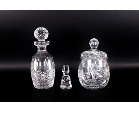 Cut Glass Decanter, with star cut base and stopper. Together with a glass biscuit barrel. With one extra stopper.
