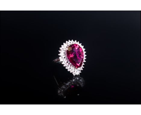 Large Ruby Colour Quartz and White Topaz Ring, a 15.75ct pear cut ruby colour quartz, framed with 3cts of marquise cut white 