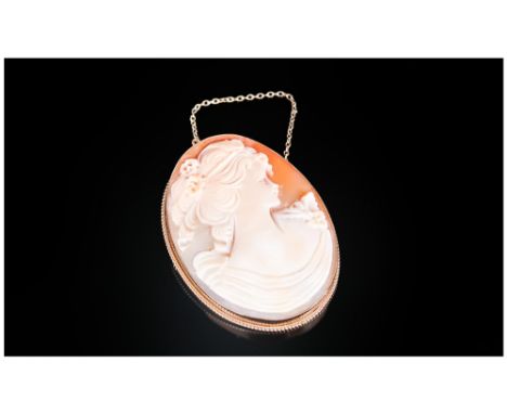 A Fine Quality Shell Cameo Brooch, Oval Shaped set in a 9ct gold mount. Hallmark London 1970. Portrait Of a young woman. 2'' 