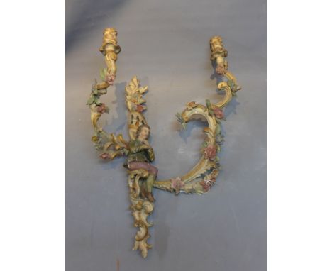 A 19th Century German carved oak two bracket wall sconce decorated with central figure and flowers