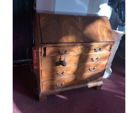 A Georgian mahogany bureau with drop down flap over four long drawers raised bracket feet, H:104cm W:91cm D:47cm