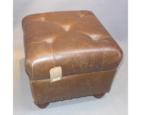 A 20th Century brown leather pouffe raised on bun feet.