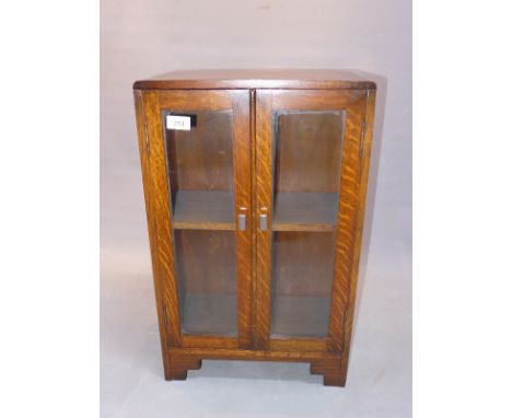 An Art Deco oak bookcase raised on bracket feet, H:61cm W:38cm D:20cm