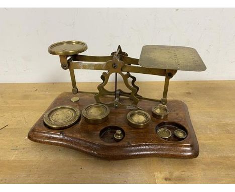 A set of vintage scales inscribed Rates of Postage Not Exceeding 1 Ounce 1d down to 16 - 5, along with collection of weights