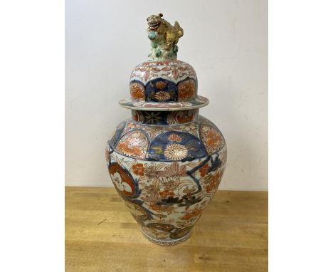 A large 19thc Japanese Imari baluster shaped vase and cover, with Lion finial, some repairs, measures 48cm high