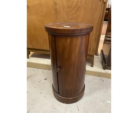 A Victorian mahogany cylindrical bedside cabinet, the curved door enclosing a single shelf, on plinth base, a/f, measures 79c