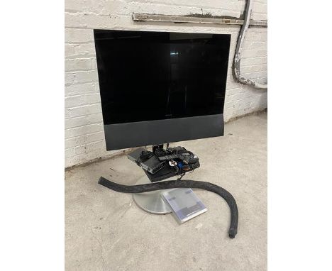 A Bang &amp; Olufsen television with sensory swing action ability, on stand, measures 24", along with a Philips DVD player et