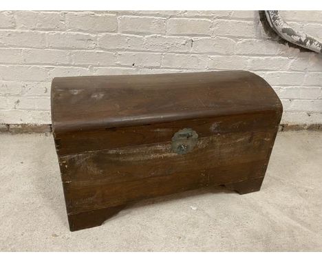 A Chinese dome topped padauk wood chest with drop handles to sides, interior single sliding shelf on bracket feet a/f, measur